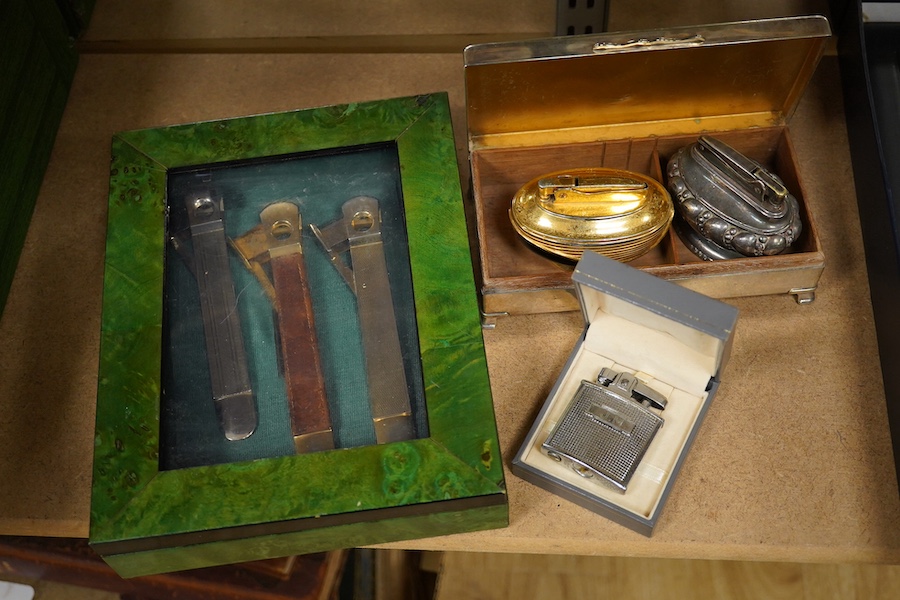 Smoking items; silver cigarette box, three various Ronson lighters and three cigar cutters. Condition - fair